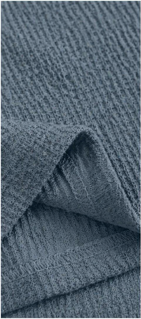 Close-up of dusty blue waffle-knit fabric made from 95% polyester and 5% spandex, showing the textured grid pattern and soft, flexible material construction