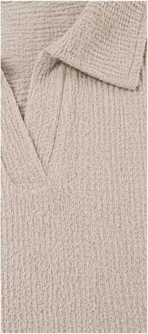 Close-up of beige waffle-knit fabric with open V-neckline and collar detail, showing the 95% polyester 5% spandex construction and signature grid texture pattern